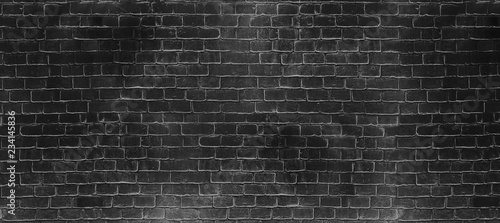 Vintage old dark black wash brick wall texture. Panoramic background for your text or image.