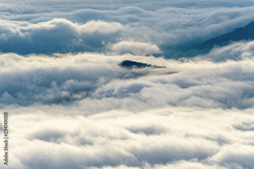 Fototapeta Naklejka Na Ścianę i Meble -  Beautiful nature landscape clouds and fogs like the sea is covered peaks in winter morning during sunrise at viewpoint of Phu Ruea National Park, Loei province, Thailand