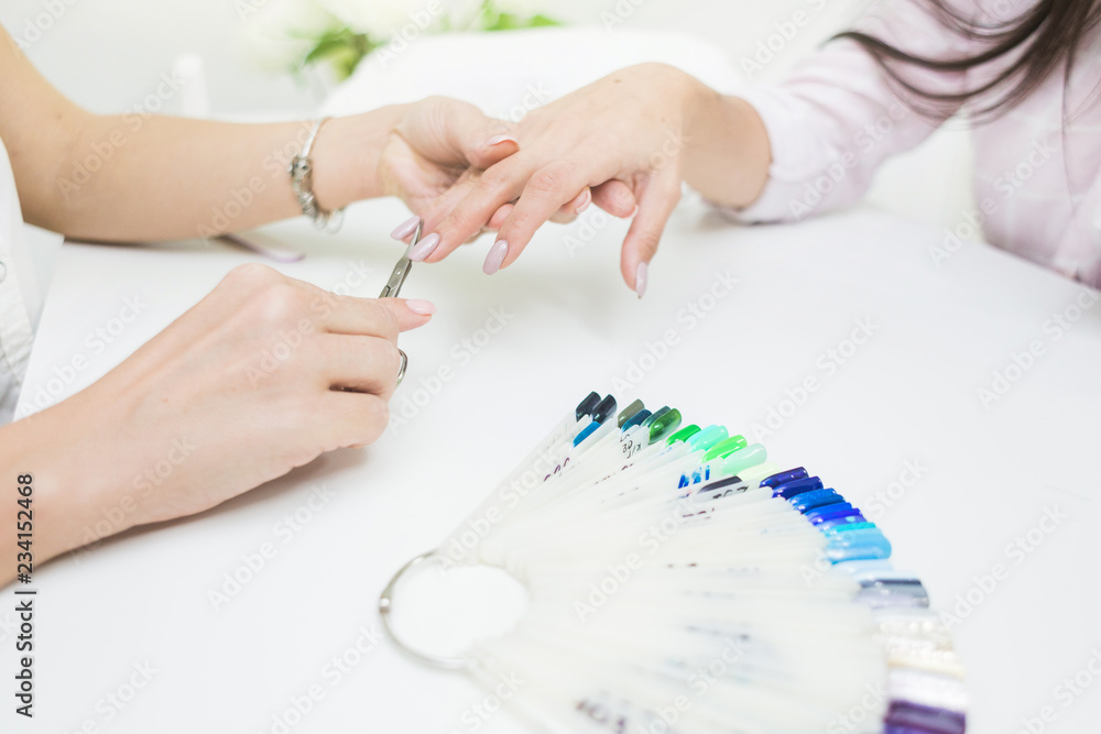 Young woman getting manicure in beauty salon. Close-up Young woman getting manicure in beauty salon. Close-up
