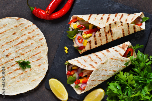 Taco - traditional dish of Mexican cuisine. Mexican tacos with beef, vegetables and sauce. Top view.