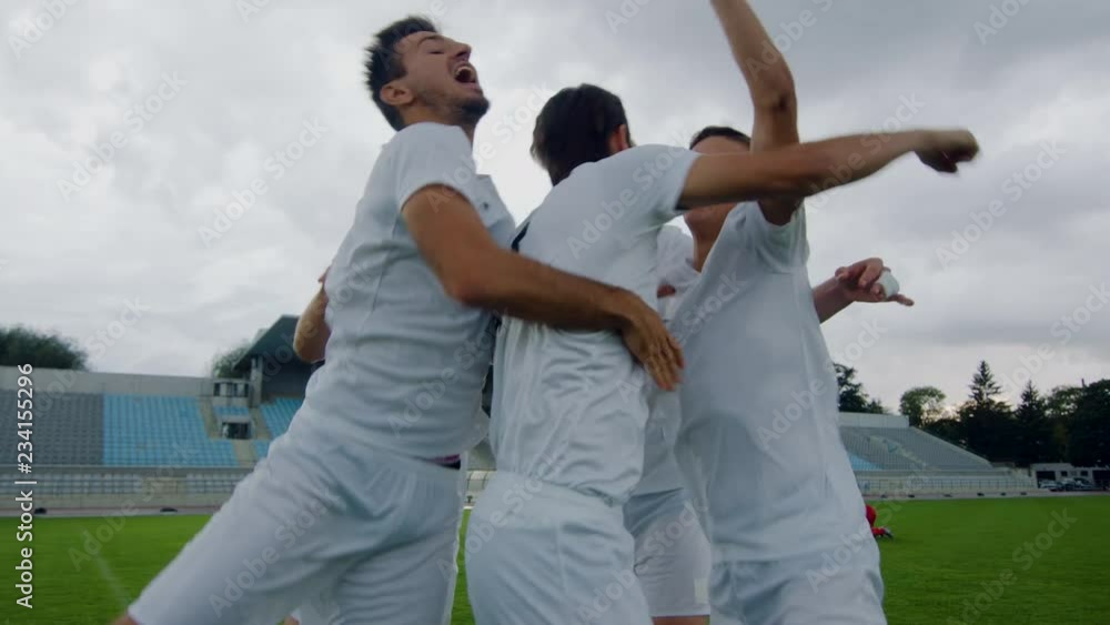 Successful Soccer Team Celebrates Victory on a Stadium. Professional Players Triumph over Winning Their Opponents. Successful Soccer Team Celebrates Victory on a Stadium. Professional Players Triumph over Winning Their Opponents.
