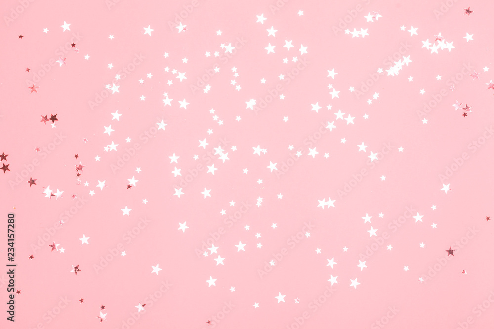 Pink confetti and stars and sparkles on pink background. Top view, flat lay. Copyspace for text. Bright and festive holiday background. For Christmas, New year, Mother's day. Pink confetti and stars and sparkles on pink background. Top view, flat lay. Copyspace for text. Bright and festive holiday background. For Christmas, New year, Mother's day.