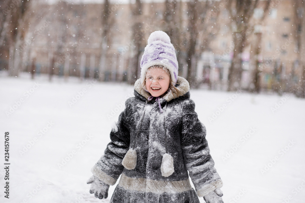 Cute little girl covered with snow has fun in winter park, Cute little girl covered with snow has fun in winter park,
