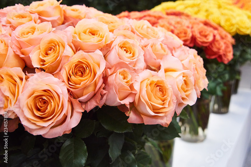 Fresh cut yellow and light pink roses and arrangements in florist shop  tracking shot