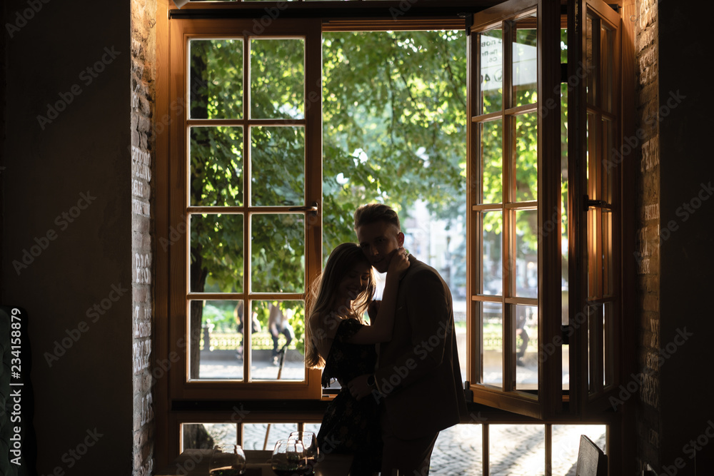Obraz premium Young couple by the window