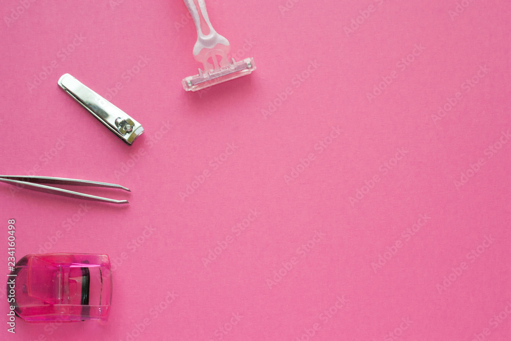 Woman make up equipment - tweezers, plastic eyelash curler and nail clippers on pink background. Copy space for text. Woman make up equipment - tweezers, plastic eyelash curler and nail clippers on pink background. Copy space for text.