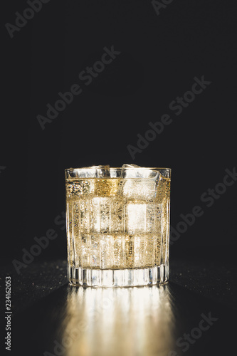 Obraz na płótnie dark background whiskey ice glass ice hand photo moody pouring alcohol bourbon bartender bar hotel home w salonie