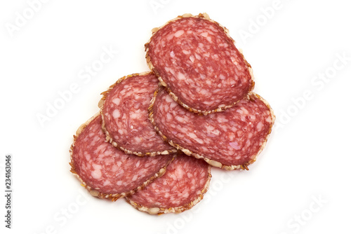 Sliced salami sausage with sunflower seeds, isolated on white background. Close-up.