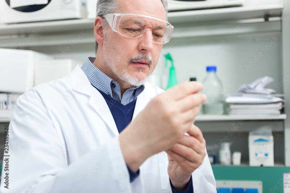 Scientist holding a test tube in his laboratory Scientist holding a test tube in his laboratory