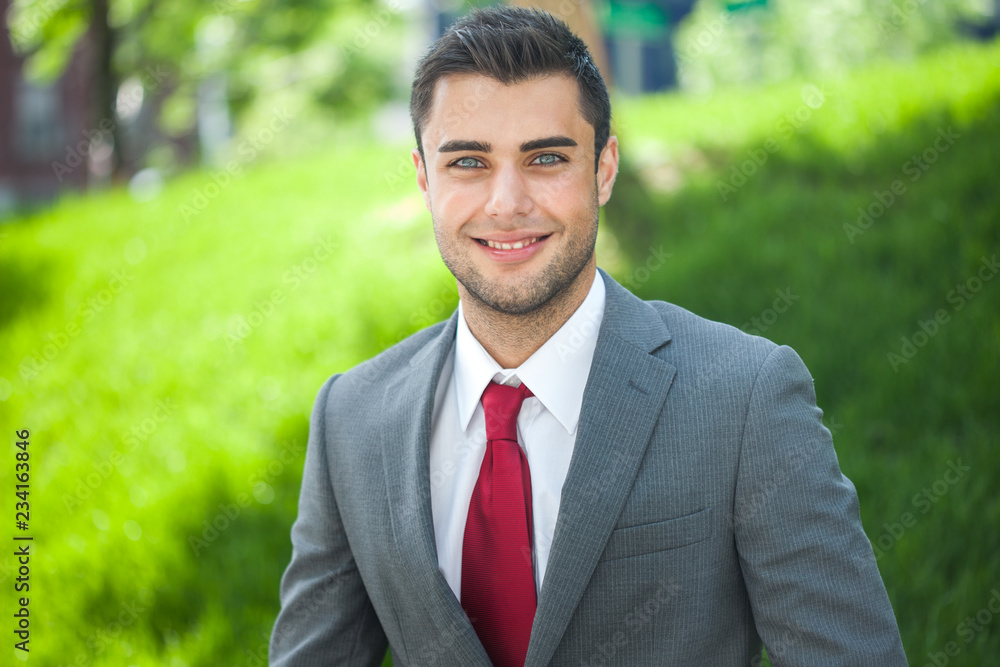 Portrait of a young handsome businessman relaxing in a park Portrait of a young handsome businessman relaxing in a park