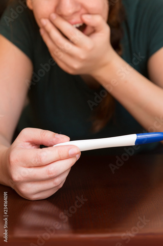 Excited Woman Looking at Her Pregnancy Test