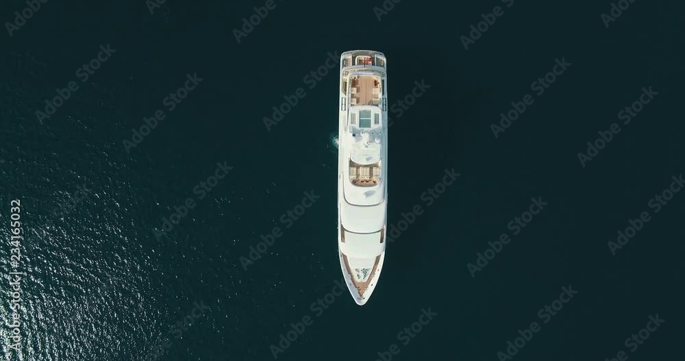 Top-down aerial view of large white yacht, camera movement up Top-down aerial view of large white yacht, camera movement up