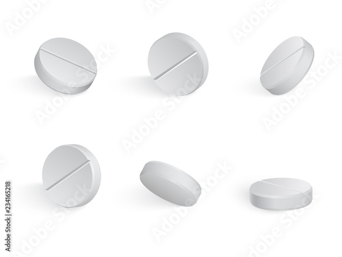Round white medical tamblets in different positions.