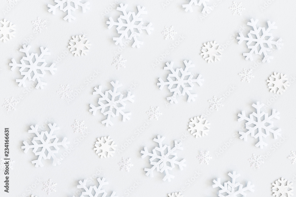 Christmas or winter composition. Christmas pattern made of snowflakes on pastel gray background. Flat lay, top view Christmas or winter composition. Christmas pattern made of snowflakes on pastel gray background. Flat lay, top view