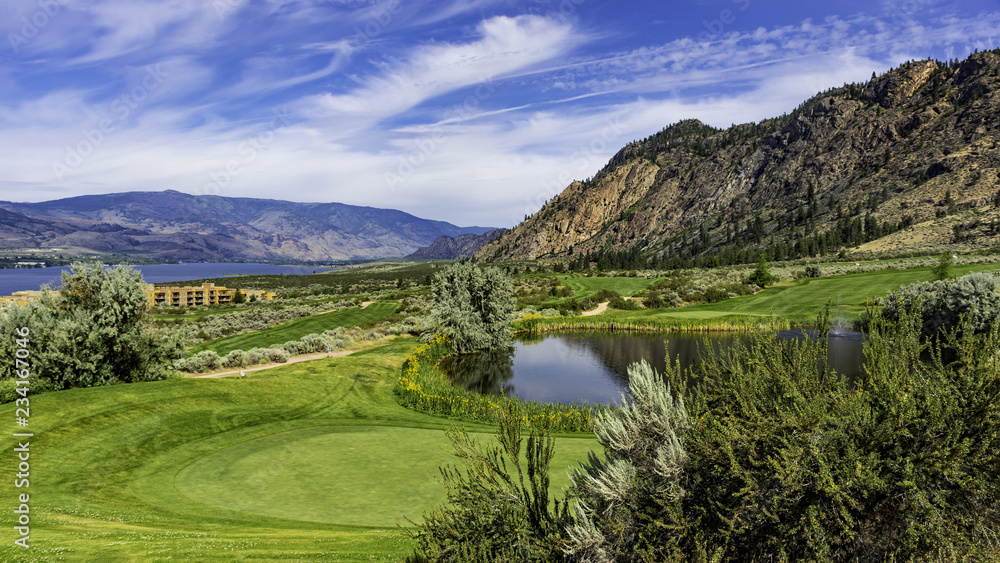 Obraz premium A golf course in the Okanagan Valley near Osoyoos British Columbia Canada with Osoyoos Lake in the background