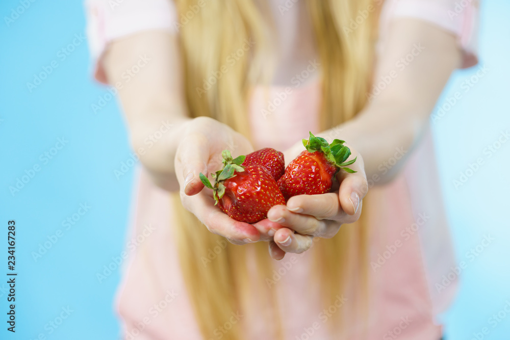 Girl showing fresh strawberries Girl showing fresh strawberries