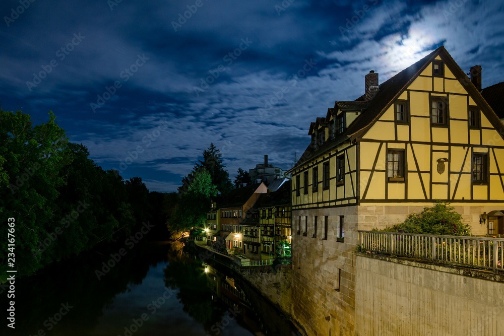 Historic building in a full moon lit night with the river