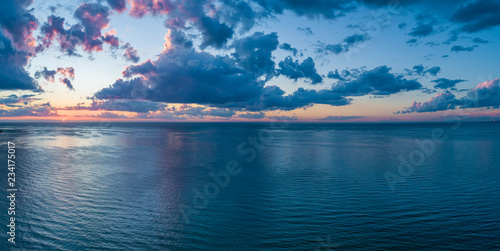 Aerial panorama of sunset over ocean