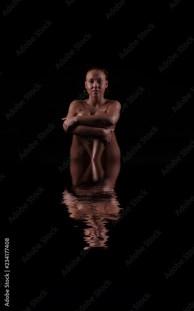 nude woman on a dark background