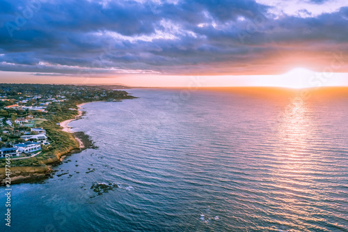 Sunset over ocean near coastline aerial view © Greg Brave