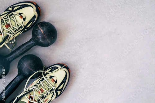 Sneakers and old dumbbells, a top view, the concept of healthy lifestyle