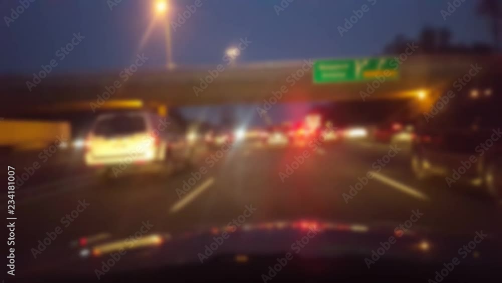 Driving Through Heavy City Highway Traffic Jam at Night With Blur Effect. Driver Point of View POV. Interstate or Turnpike or Expressway or Freeway or Motorway Traffic. Driving Through Heavy City Highway Traffic Jam at Night With Blur Effect. Driver Point of View POV. Interstate or Turnpike or Expressway or Freeway or Motorway Traffic.
