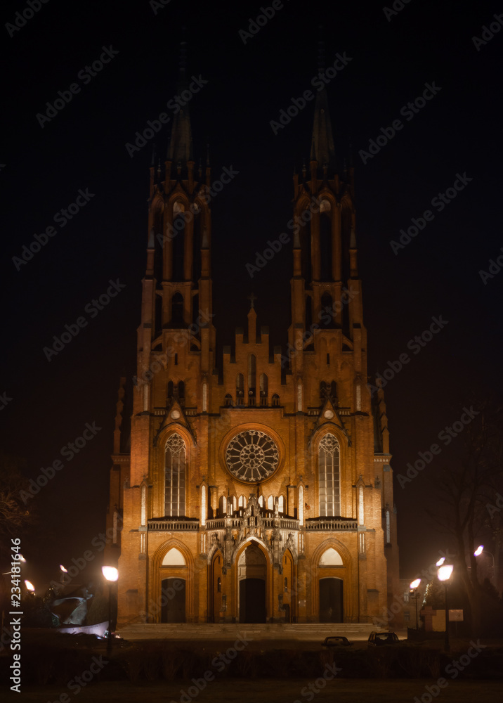 Gothic medieval cathedral with central round window. Medieval church at night. Roman style window.