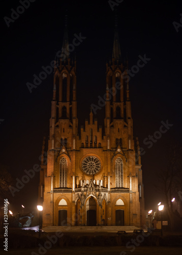 Gothic medieval cathedral with central round window. Medieval church at night. Roman style window.