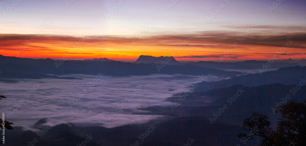 Mountain and foggy at morning time with orange sky, beautiful landscape in the thailand