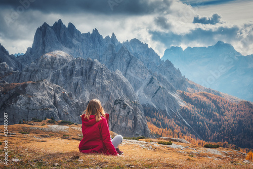 Young woman is sitting on t...