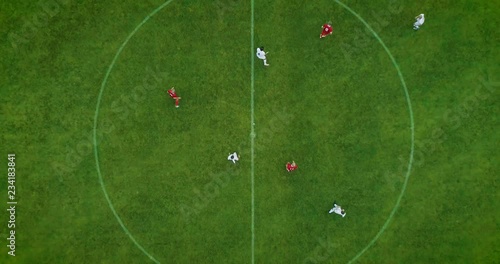 Aerial Top Down View of Soccer Field and Two Professional Teams Playing. Kick off Start of the Energetic Match on International Championship photo