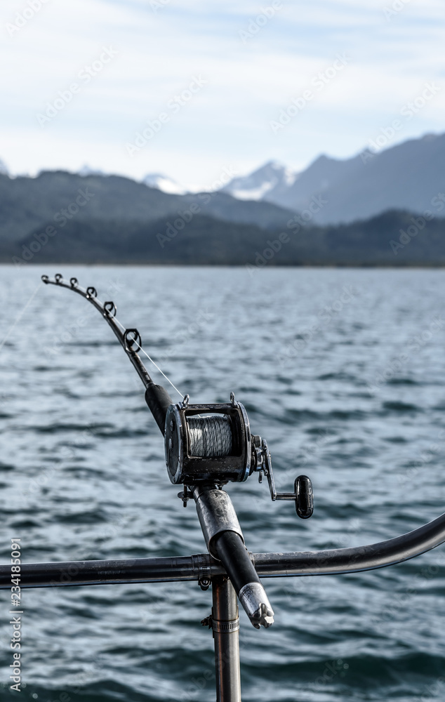 Deep Sea Fishing Rod and Reel in a Rod Holder on the Gunnel of a Boat in  Alaska Stock Photo