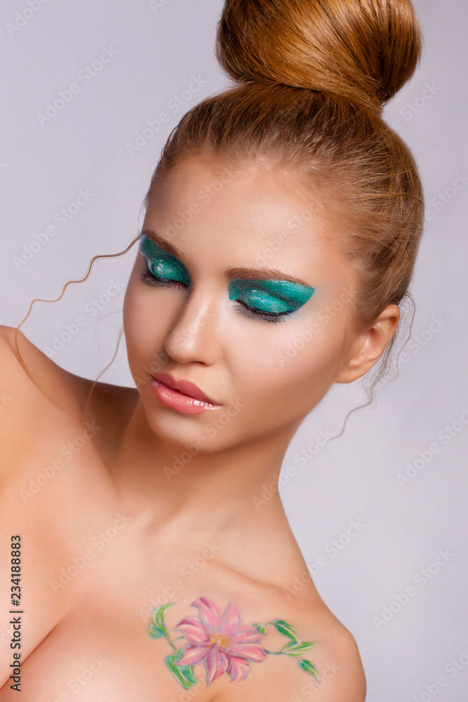 Fototapeta premium Young beautiful girl in a bright spring image with closed eyes on a colored background