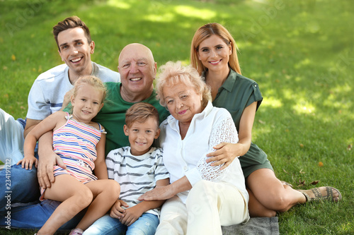 Couple with children and elderly parents in park