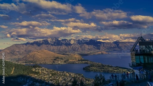 Timelapse of evening in Queenstown, New Zealand, observed from Gondola cable car top station. Shot from daylight through the sunset until the street lights turn on.