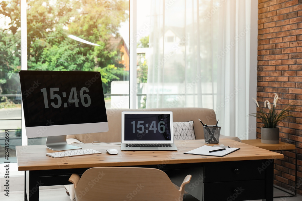 Fototapeta premium Stylish workplace with modern computers in home office