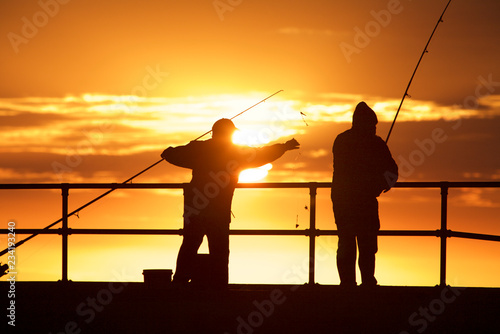 Obraz na płótnie Fishing men at the beach w salonie
