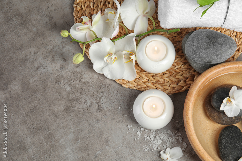 Flat lay composition with spa stones and candles on gray background. Space for text Flat lay composition with spa stones and candles on gray background. Space for text