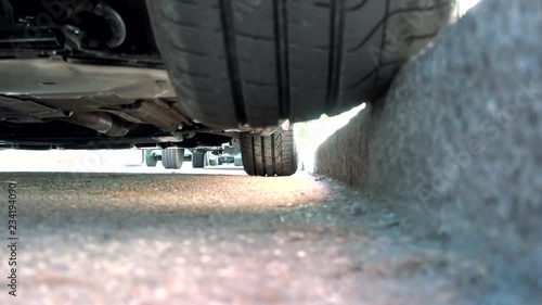 Bad car parking with half tire on the curb at risk of damage