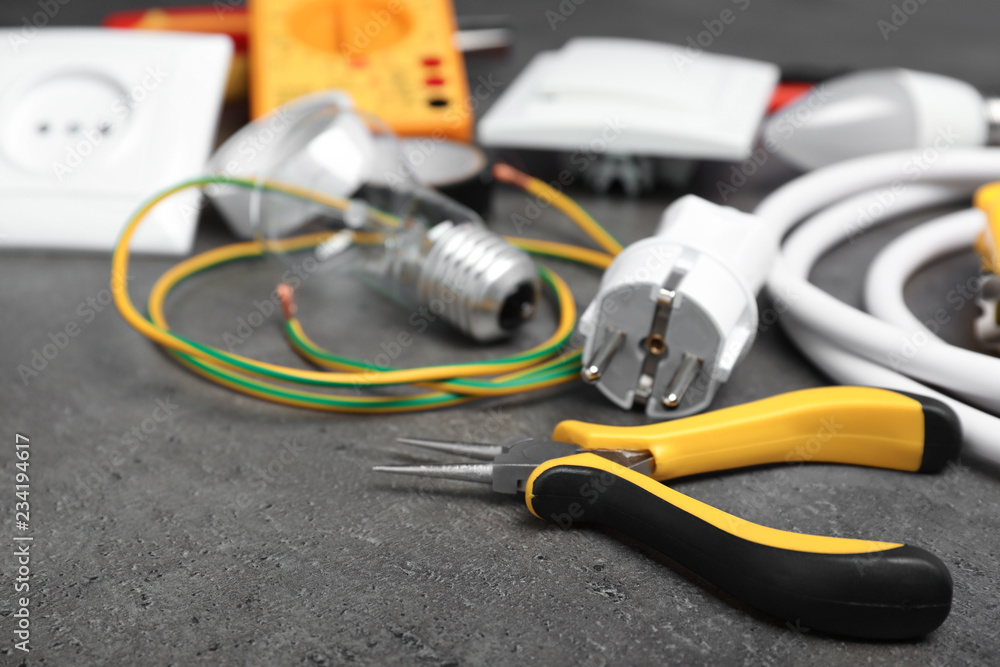 Set of electrician's tools on gray table Set of electrician's tools on gray table