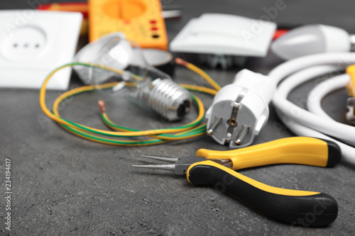 Set of electrician's tools on gray table