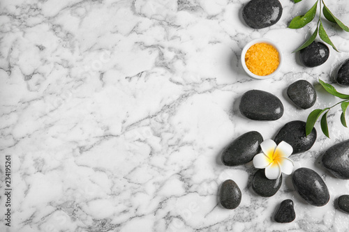Flat lay composition with spa stones and space for text on marble background