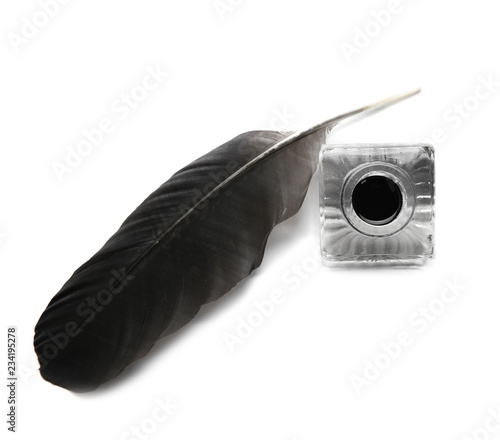 Feather pen and inkwell on white background, top view