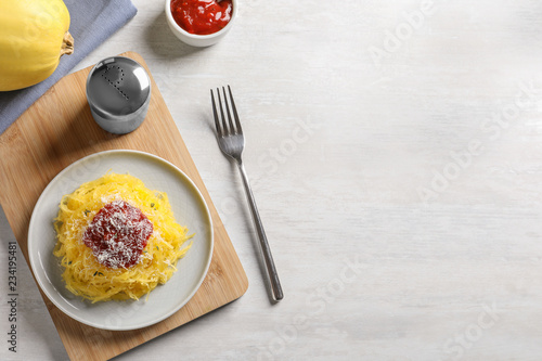 Flat lay composition with cooked spaghetti squash and space for text on white table