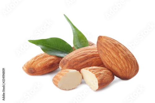 Organic almond nuts and leaves on white background. Healthy snack