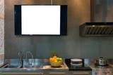 Modern kitchen with stainless steel sink and television on the wall, space text for advertisement