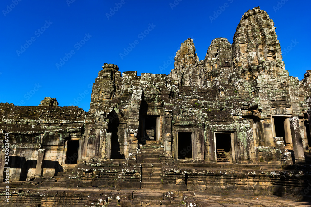 Ruin stone Ancient Bayon Temple in Cambodia with blue sky