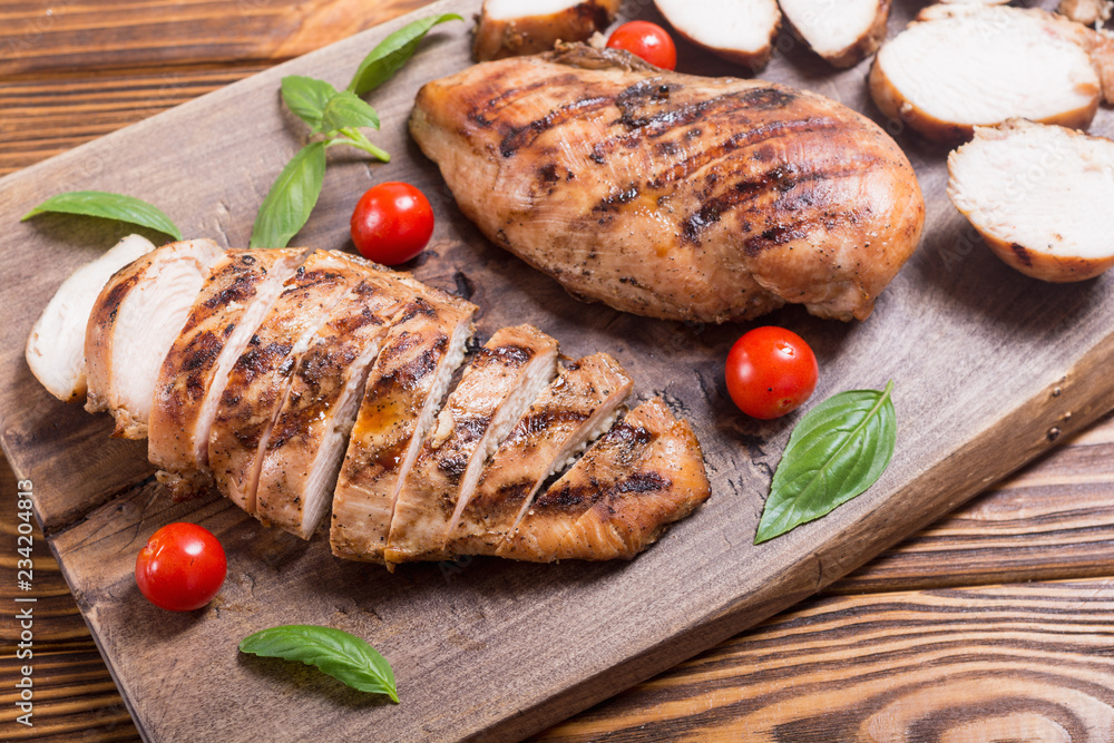 Grilled chicken breast ( fillet ) with basil and tomatoes Stock Photo