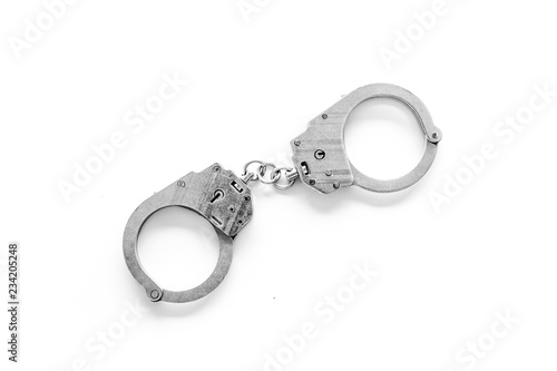 Metal handcuffs on white background top view copy space