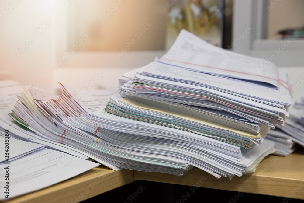 Business and finance concept of office working, Pile of unfinished documents on office desk, Stack of business paper Business and finance concept of office working, Pile of unfinished documents on office desk, Stack of business paper